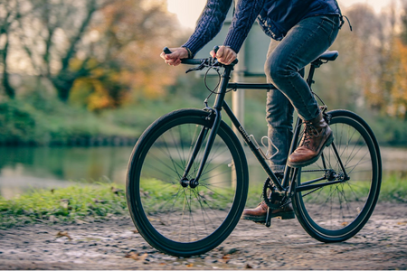 Man on an ebike cycling through the mud