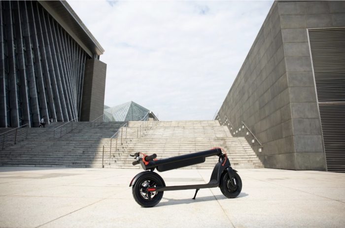 Folded electric scooter with brake on.